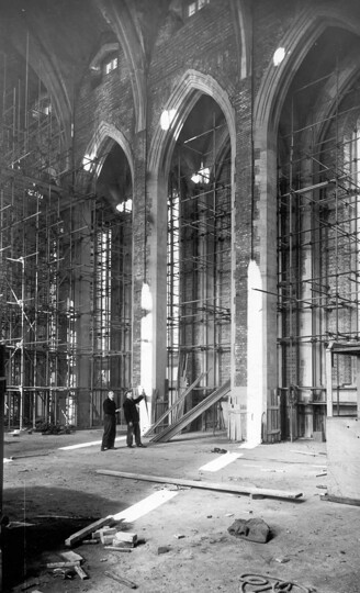 Photograph of the interior of the Nave during construction, showing the arches clad in scaffolding