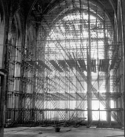 Photograph of a vast matrix of scaffolding against the open west-end of the Cathedral