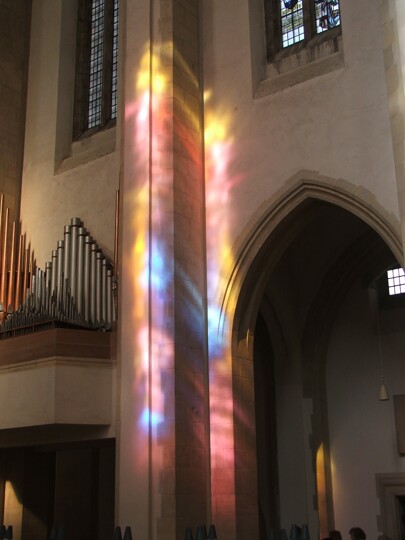Photograph of light from the service window shining onto a pillar in the Chancel