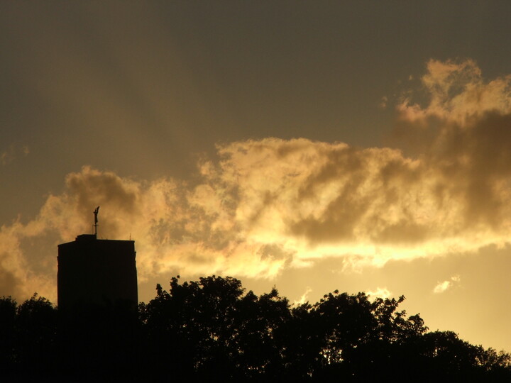 Photograph of a golden sunset with the Cathedral tower silhouetted.