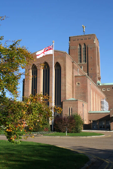 Photograph of the west end of the Cathedral, with a White Ensign flying in the foreground